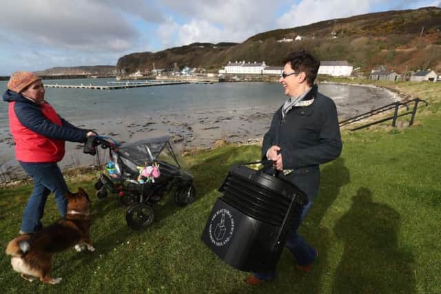 Senior presiding officer and polling station manager Teresa McCurdy arrives on Rathlin Island, off the north east coast of Northern Ireland, with the ballot box in which the island's population of just over 100 people will cast their votes during Thursday Assembly election.