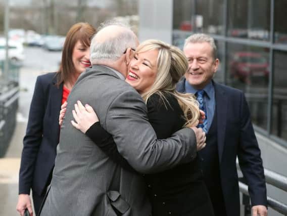 Michelle O'Neill, leader of Sinn Fein in Northern Ireland, is hugged by Francie Molloy as she arrives at the Seven Towers Leisure Centre, Ballymena, where election count staff are counting ballot papers in Northern Ireland's Assembly election.