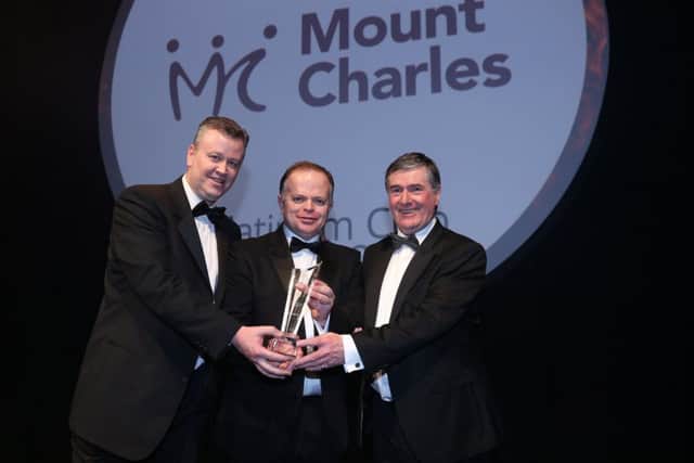 Mount Charles MD Cathal Geoghegan, left, and chairman Trevor Annon, right, with Richard Howard of Deloitte Ireland