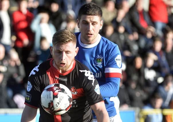 Crusaders David Cushley in action with Linfield's Mark Haughey