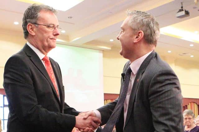 Mike Nesbitt is congratulated by rival John McCallister after becoming UUP leader in March 2012