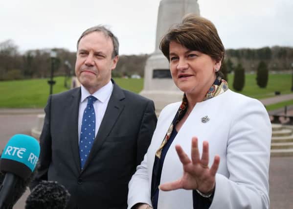 DUP leader Arlene Foster and deputy leader Nigel Dodds speaking to the media outside Stormont in Belfast yesterday. Photo: Niall Carson/PA Wire