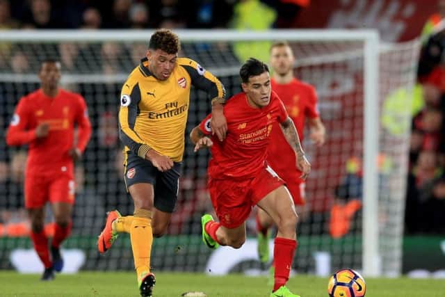 Alex Oxlade-Chamberlain tracks Liverpool's Philippe Coutinho during Arsenal's 3-1 defeat at Anfield.