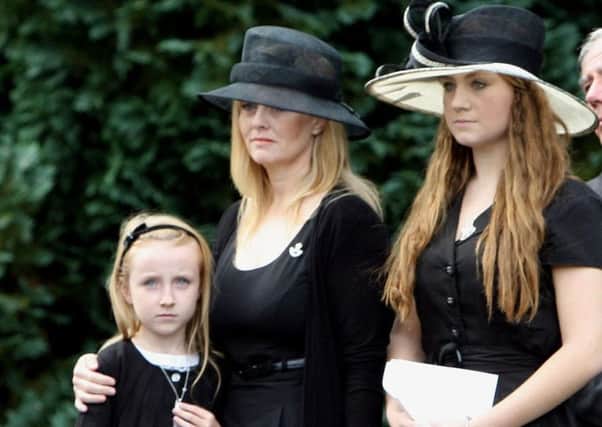 Brenda Hale with her daughters Alex (left) and Tori at the 2009 funeral of her Army husband Mark