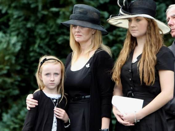 File photo dated 02/09/09 of Brenda Hale (centre) at the funeral of her husband Captain Mark Hale in Hillsborough Co Down, with her two daughters Alex (left) and Tori (right).