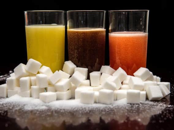 File photo dated 22/07/15 of carbonated drinks surrounded by sugar cubes. Chancellor Philip Hammond will deliver his Budget statement on Wednesday.