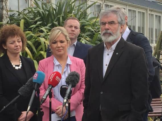 Sinn Fein's Michelle O'Neill (centre) and Gerry Adams (right) with other Assembly members speaking outside Stormont Castle.