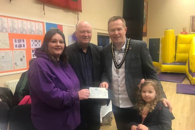 Lynsey Sterritt receives a cheque from Deputy Lord Mayor Paul Greenfield and local MP David Simpson for Elsa fundraiser in Banbridge Orange Hall.  Also pictured is Sophia Greenfield.