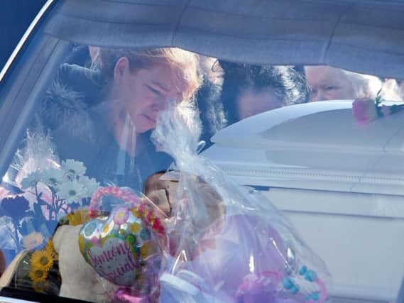 Mourners at the funerals of pregnant mother Annmarie O'Brien, daughter Paris and Holly and Jordan O'Brien who died in a fire arriving at St Anne's Church, Shankill, Dublin.