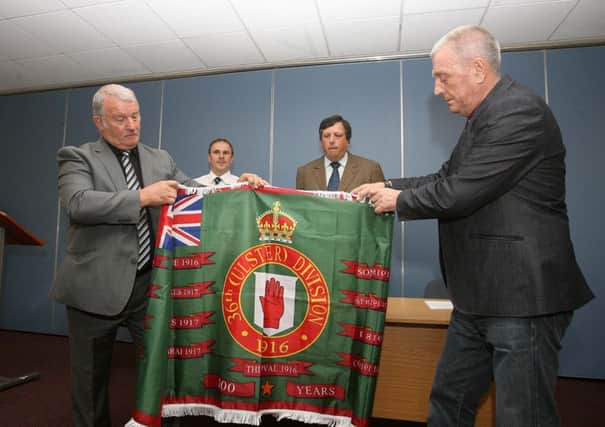 Jim Wilson, left, helps to unveil a new flag for the centenary of the Battle of the Somme by the Loyalist Communities Council (LCC) with Jackie McDonald and Winston Irvine and David Campbell. 
Picture By: Pacemaker Press. May 2016