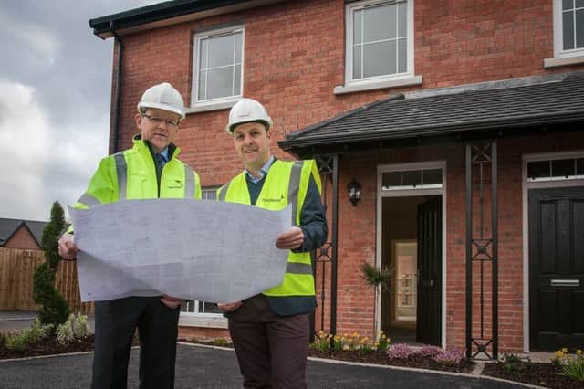 Conor Mulligan and Stephen Bell outside the completed houses