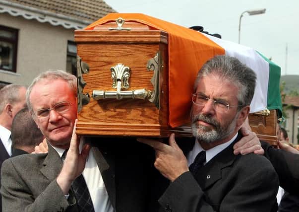 Martin McGuinness carries the coffin of IRA leader Brian Keenan in 2008, as does Gerry Adams, right. Photo: Paul Faith/PA Wire