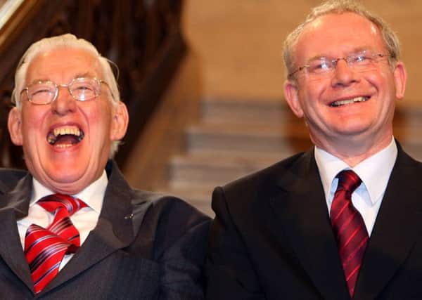 Then First Minister Ian Paisley and deputy First Minister Martin McGuinness smiling after being sworn in as ministers of the Northern Ireland Assembley, Stormont. Photo: PA