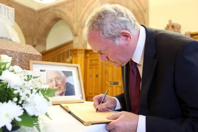 Martin McGuinness signs a book of condolence for Ian Paisley in September 2014