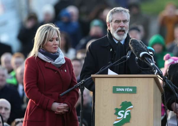 Sinn Fein's Michelle O'Neill and Gerry Adams speak at Derry City Cemetery, in Londonderry, after the funeral service of Northern Ireland's former deputy first minister and ex-IRA commander Martin McGuinness. Photo: Brian Lawless/PA Wire