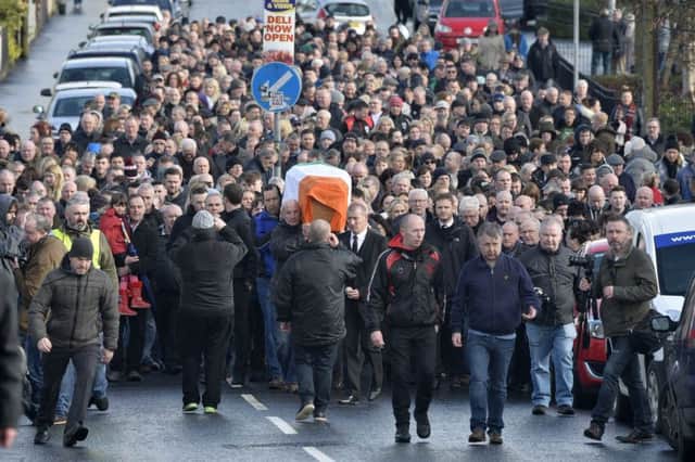 Mourners follow Martin McGuinnesss coffin as it is returned to his home in the Bogside on Tuesday afternoon