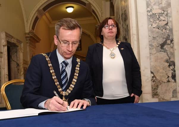 Belfast Lord Mayor Brian Kingston signs the book of condolence at City Hall