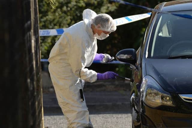 Police forensics on the scene of the murder at Sunningdale Gardens off the Ballysillan Road in Belfast last August