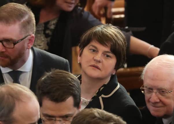 Arlene Foster at the funeral service with Simon Hamilton (left)