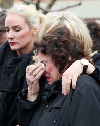 Martin McGuinness's wife Bernie is comforted outside his home in the Bogside ahead of the funeral of Northern Ireland's former deputy first minister and ex-IRA commander. Paul faith/PA Wire
