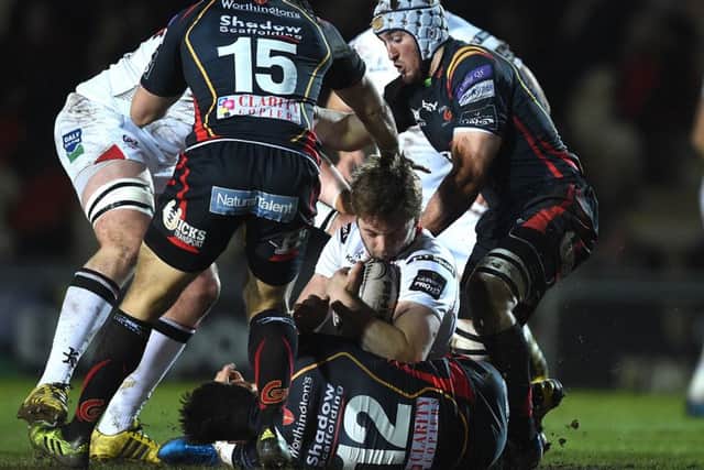 Iain Henderson of Ulster is tackled by Sam Beard of Dragons.