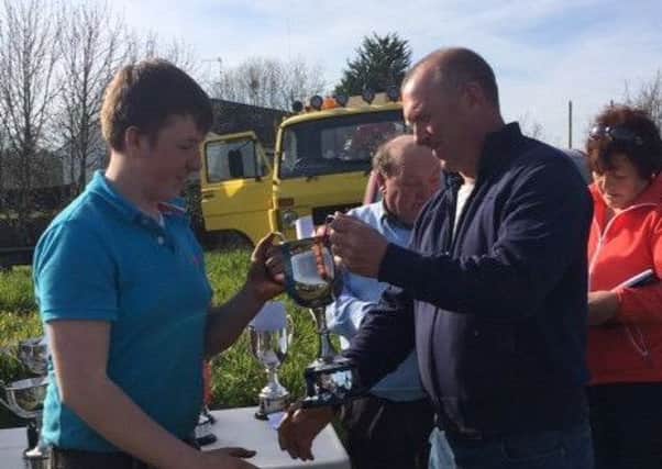 Peter Allen (Donacloney) receives his prize from Wilfie Gill for his class win at Ballynahinch Vintage Clubs ploughing match held in Crossgar last Saturday