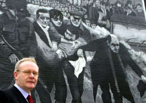 The late Martin McGuinness in front of a Bloody Sunday mural in the Bogside in Londonderry. Photo: Paul Faith/PA Wire