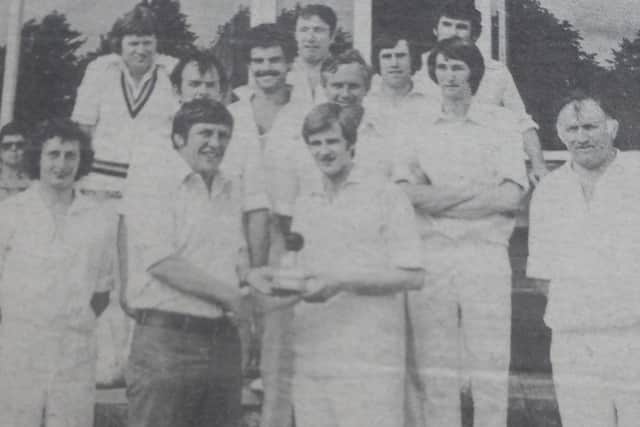 Ian Clarke, then president of Lurgan Rugby Football and Cricket Club, presents Alan Johnston with the ball he used when taking all ten wickets in a match against Bangor in 1977. Included are team members, back from left, Tom Guy, Dickie Maxwell, Michael Lumb, Eric Sands, Jim Harland, Reggie McNally, Denis Guy, Denis Johnston, front left, Stanley Beattie, front right, Ray Hunter.