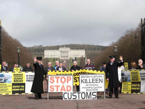 Anti-Brexit campaigners, some dressed as customs officers hold a protest outside Stormont in Belfast, as Prime Minister Theresa May triggers Article 50, starting the process that will see Britain leave the EU.