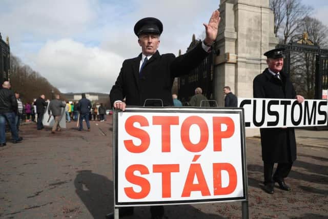 Anti-Brexit campaigners dressed as customs officers, protest outside Stormont in Belfast, as Prime Minister Theresa May triggers Article 50, starting the process that will see Britain leave the EU.