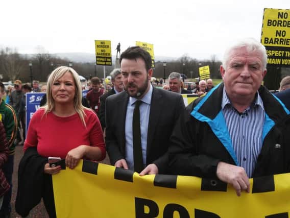Sinn Fein leader in Northern Ireland Michelle O'Neill and SDLP leader Colum Eastwood (centre) take part in an Anti-Brexit protest outside Stormont in Belfast, as Prime Minister Theresa May triggers Article 50, starting the process that will see Britain leave the EU.
