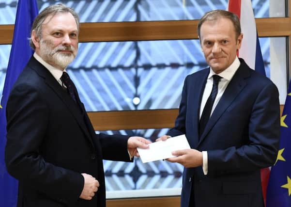 EU Council President Donald Tusk, right, gets British Prime Minister Theresa May's formal notice to leave the bloc from UK Permanent Representative to the EU Tim Barrow in Brussels. (Emmanuel Dunand, Pool via AP)