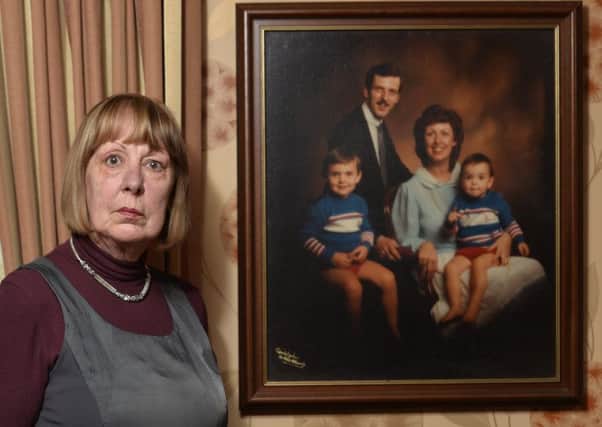Avril Anderson with a photo of her husband Billy Wilson and their two sons, taken shortly before he was murdered