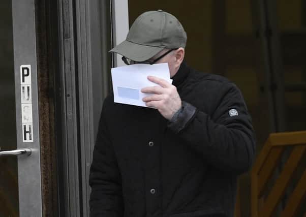 Henry Fitzsimons disguising his face at a previous court appearance in January