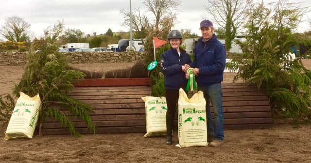 Winner of the 90cm class Alex Greer receiving her prize from Eric Pele