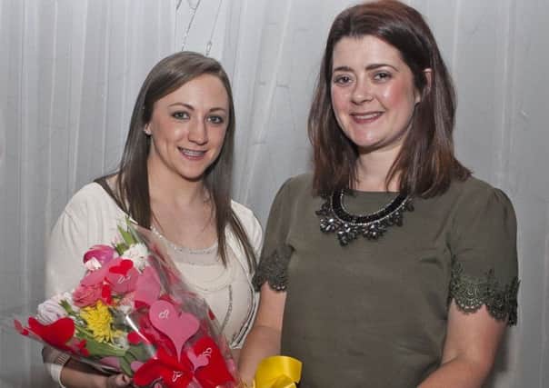 Grace Cassley (left), who presented the awards on Friday night, pictured receiving a bouquet of flowers from Tracey McAllister.