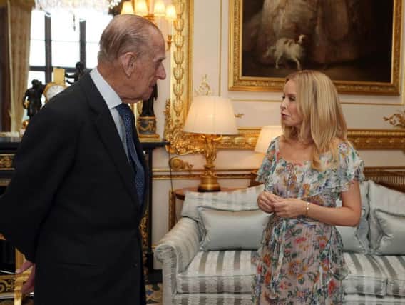 The Duke of Edinburgh, Patron of the Britain-Australia Society, presents Kylie Minogue with the Britain-Australia Society Award for 2016 during a private audience in the White Drawing Room at Windsor Castle, in Berkshire.