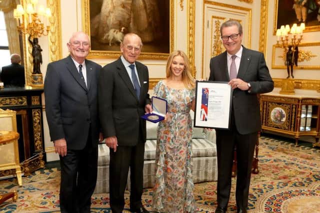 The Duke of Edinburgh (second left), Patron of the Britain-Australia Society, presents Kylie Minogue with the Britain-Australia Society Award for 2016, with Britain-Australia Society chairman Peter Benson (left) and Australian High Commissioner to the the UK Alexander Downer, during a private audience in the White Drawing Room at Windsor Castle, in Berkshire.