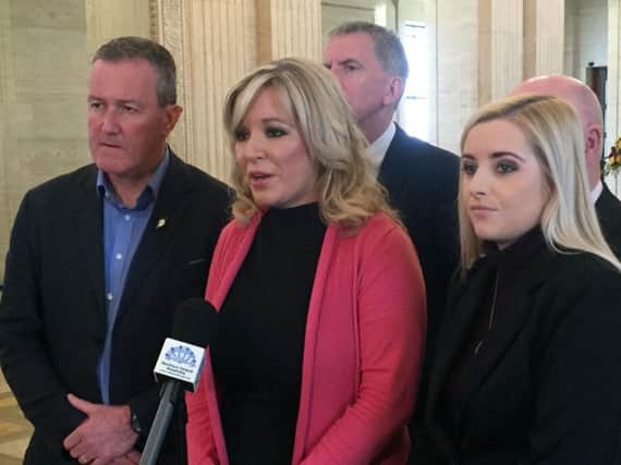 Sinn Fein's Michelle O'Neill addresses the media surrounded by party colleagues in the Great Hall of Parliament Buildings, Stormont.