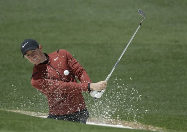 Rory McIlroy hits from a bunker on the second hole during the first round at the Masters