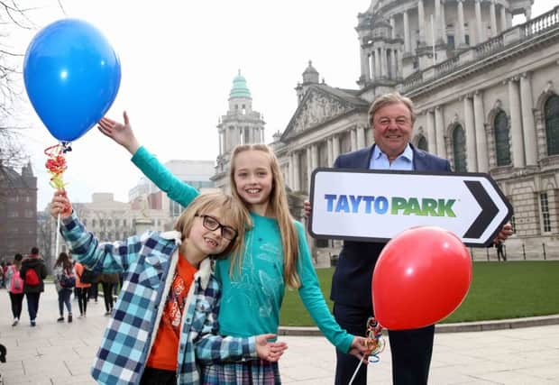 Raymond Coyle pictured in Belfast with two young Tayto Park fans