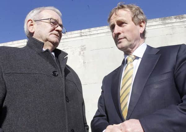 Kingsmills Massacre survivor Alan Black with Taoiseach Enda Kenny in Bessbrook in 2015, where Mr Kenny promised full cooperation with the inquest. However lawyers for the families are now accusing the Irish government of throwing up legal road blocks to assisting the legacy inquest get to the truth behind the IRA atrocity.