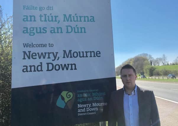 UUP councillor David Taylor stands at one of the bi-lingual Irish-English signs at the boundary of Newry Mourne and Down District Council. He has expressed concern about the use of the Irish language in his council in light of debate about a possible Northern Ireland-wide Irish Language Act.