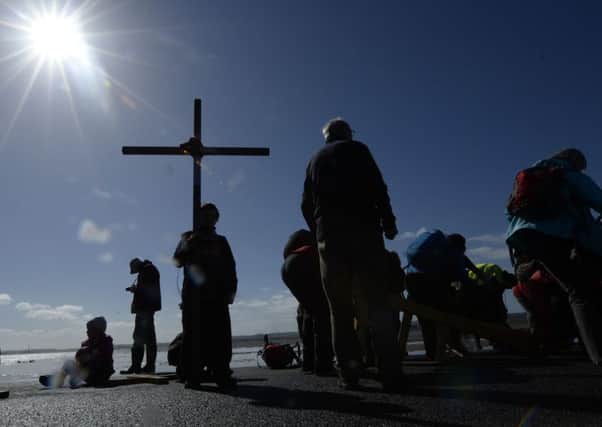Pilgrims cross from Beal sands to the Holy Island of Lindisfarne in Northumberland during the annual Christian Easter pilgrimage on Good Friday, 2014. Photo: Owen Humphreys/PA Wire