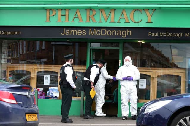 The scene of the incident at a chemist in west Belfast .