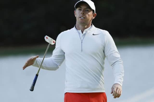 Rory McIlroy of Northern Ireland, drops his putter on the 13th hole during the third round of the Masters