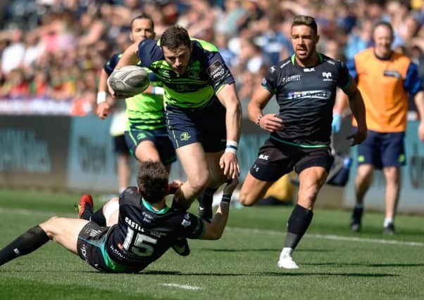 Leinster's Robbie Henshaw is tackled by Sam Davies of Ospreys