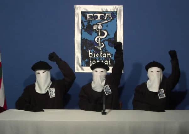 Masked members of the Basque terror group ETA gesture following a news conference at an unknown location in 2011.  (AP Photo/Gara via APTN)