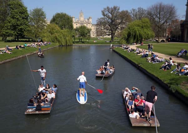 Punt rides make their way along the River Cam in Cambridge, where temperatures reached almost 80F on Sunday. Photo: Chris Radburn/PA Wire