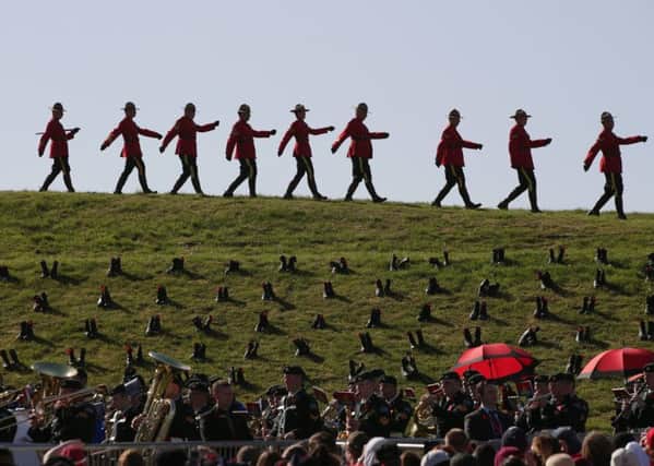 Royal Canadian Mounted Police officers march past boots placed at the site by Canadian and French youths to represent Canadians killed in the battle - during a commemorative ceremony at Vimy Memorial Park in France, during commemorations for the 100th anniversary of the Battle of Vimy Ridge. Photo: Yui Mok/PA Wire